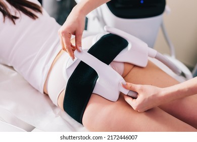 Woman getting ems treatment on buttocks to burn fat, build muscles and remove cellulite. Professional beauty salon