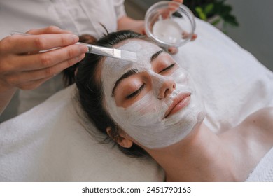 Woman getting facial care by beautician at spa salon. Face peeling mask, spa beauty treatment, skincare. - Powered by Shutterstock