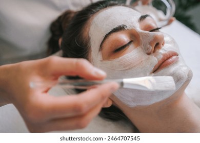 Woman getting facial care by beautician at spa salon, side view, close-up Face peeling mask, spa beauty treatment, skincare. - Powered by Shutterstock