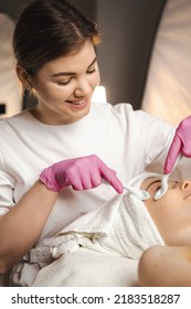 Woman Getting A Facial Massage With Porcelain Spoons Around Her Eyes At The Beauty Salon. Beauty Treatment. Facial Treatment. Beauty Face.