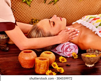 Woman getting facial massage in tropical beauty spa. Rest and recovery