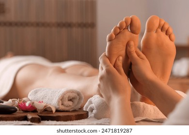 Woman getting foot massage in dark spa salon, closeup - Powered by Shutterstock