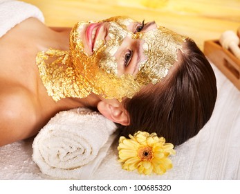 Woman Getting Gold Facial Mask.