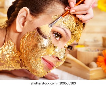 Woman Getting  Gold Facial Mask.