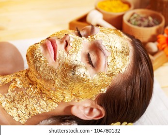 Woman Getting  Gold Facial Mask.