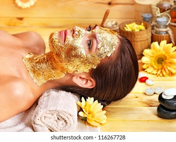 Woman Getting  Gold Facial Mask.