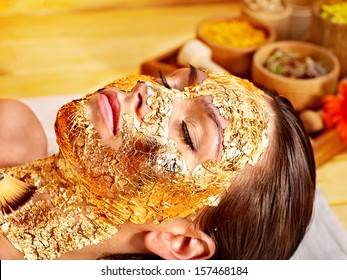 Woman Getting  Gold Facial Mask.