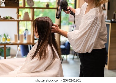 A Woman Getting Her Hair Cut At A Beauty Salon