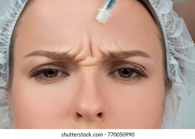 Woman is getting injection. Anti-aging treatment and face lift. Cosmetic Treatment. Facial skin lifting injection to woman's face. Plastic Surgery