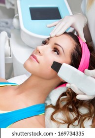 Woman Getting Laser Face Treatment In Medical Spa Center 