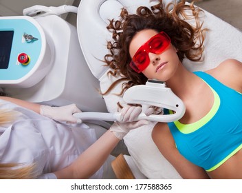 Woman Getting Laser Face Treatment In Medical Spa Center 