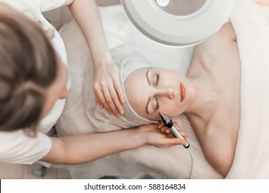 Woman Getting Laser And Ultrasound Face Treatment In Medical Spa Center, Skin Rejuvenation Concept.