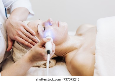 Woman Getting Laser And Ultrasound Face Treatment In Medical Spa Center 