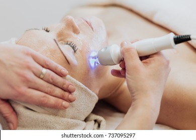 Woman Getting Laser And Ultrasound Face Treatment In Medical Spa Center