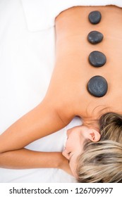 Woman getting a massage with hot stones
