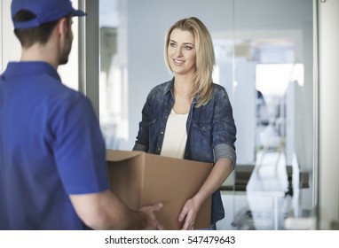 Woman Getting A Parcel From Delivery Man 