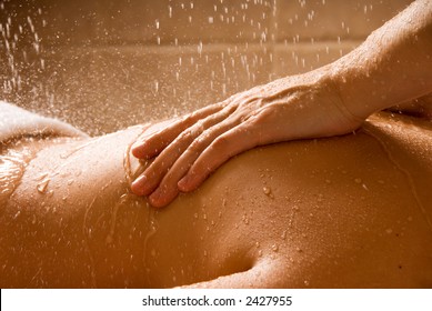 woman getting a rain massage in a day spa