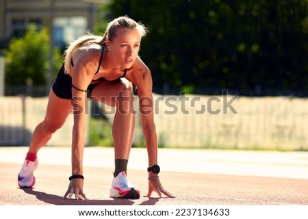 Woman getting ready to start on Stadium - summer outdoors training.
