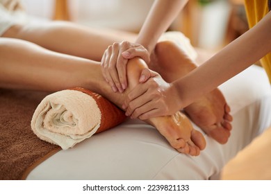 Woman getting relaxing feet massage with oils after long day
