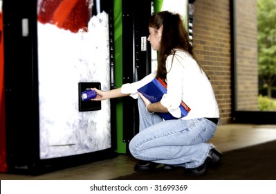 Woman Getting Soda From Vend Machine