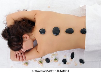 Woman Getting Spa Treatment Isolated On White. Massage With Hot Stone