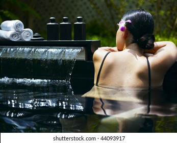 Woman getting spa treatment at tropical resort
