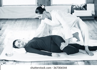 Woman getting thai stretching massage 