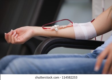 Woman getting a transfusion while sitting on a chair