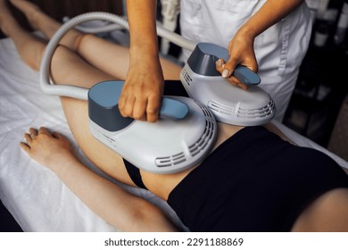 Woman getting treatment on buttocks to burn fat, build muscles and remove cellulite. Professional beauty salon - Shutterstock ID 2291188869