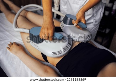 Woman getting treatment on buttocks to burn fat, build muscles and remove cellulite. Professional beauty salon