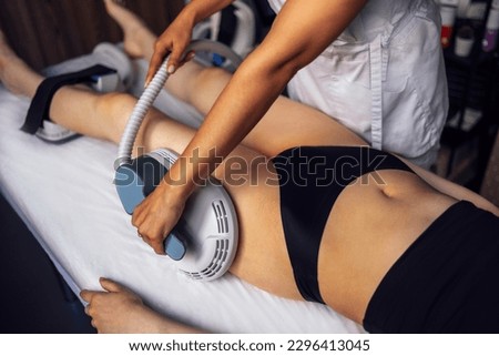 Woman getting treatment on buttocks to burn fat, build muscles and remove cellulite. Professional beauty salon