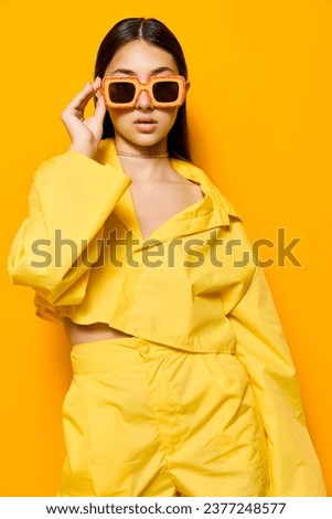 Similar – Image, Stock Photo A woman in sunglasses and a striped top holds her hair near the river with her hands