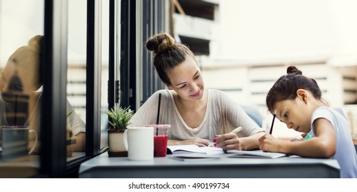 Woman And Girl Doing Homework Concept