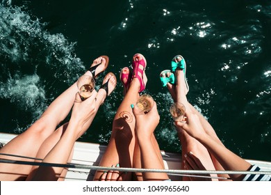 Woman, girl leg, legs in bright shoe, hills on boat, sailboat with glass of champagne. Ocean, fun, California