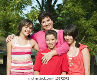 A woman with girls and a boy who appear to be her children.