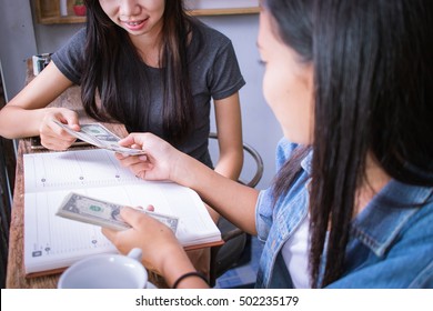 Woman Give Money For Her Friend.