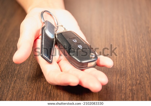 The woman gives the\
car keys. Car sale.