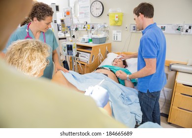 Woman giving birth using controlled breathing to push the baby - Powered by Shutterstock