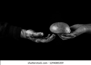 Woman Giving Bread To A Poor Man. Helping Hand Concept. Black And White