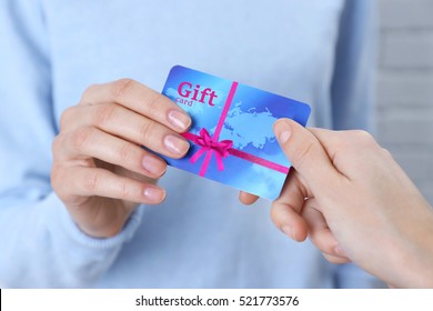 Woman Giving Gift Card To Friend, Closeup. Holiday Celebration Concept.