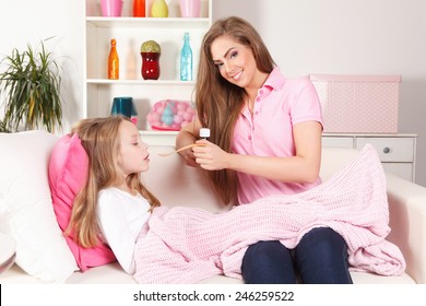 Woman Giving Medicine To Child