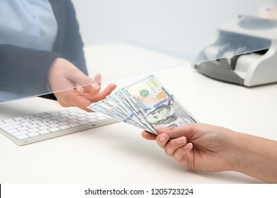 Woman Giving Money To Teller At Cash Department Window, Closeup