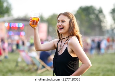 Woman With A Glass Of Beer Making Toast On Music Festival