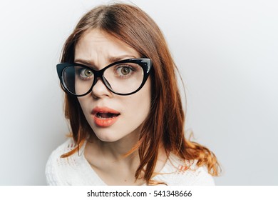 The Woman In Glasses At A Loss Does Not Understand. Looking Into The Camera