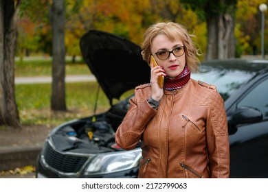 Woman With Glasses Near A Broken Car On The Road Is Calling On Mobile Phone In Service, Insurance Company, Tow Truck.