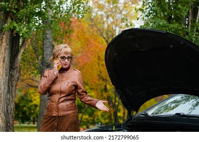 Woman With Glasses Near A Broken Car On The Road Is Calling On Mobile Phone In Service, Insurance Company, Tow Truck.