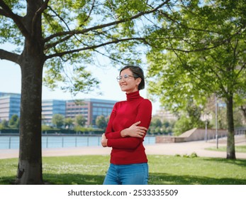 Woman in glasses and red turtleneck, dressed in business style, stands in center of Frankfurt, surrounded by modern buildings and urban life, embodying professionalism and confidence - Powered by Shutterstock