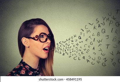 Woman in glasses talking with alphabet letters coming out of her mouth. Communication, information, intelligence concept

