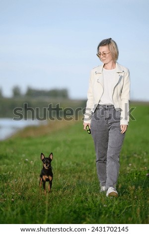 Similar – Attractive smiling blond woman with her two dogs