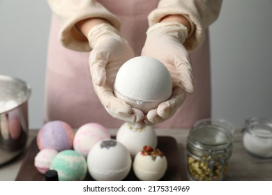 Woman In Gloves With Self Made Bath Bomb At Table, Closeup